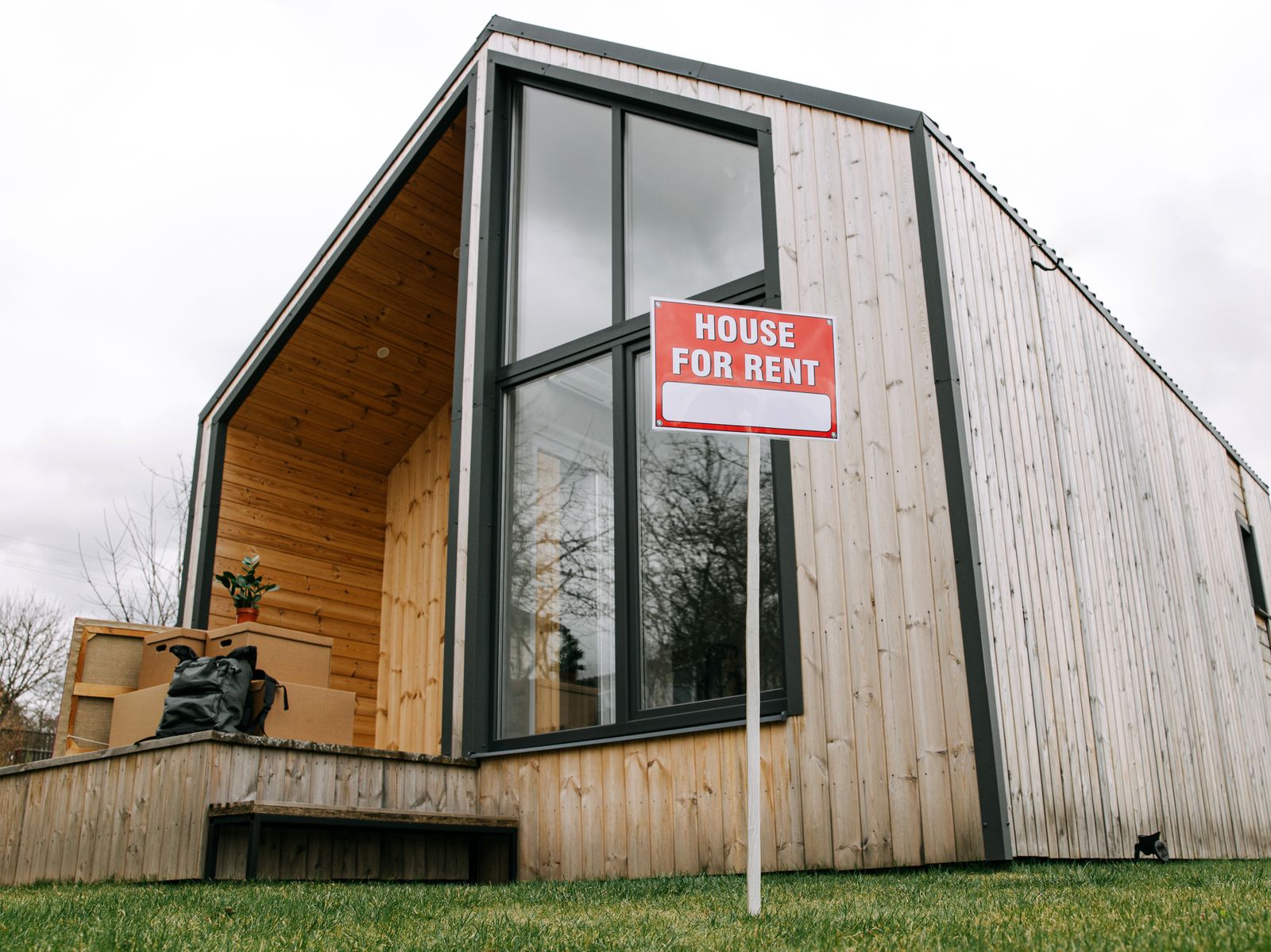 A rental house with a For Rent sign out front