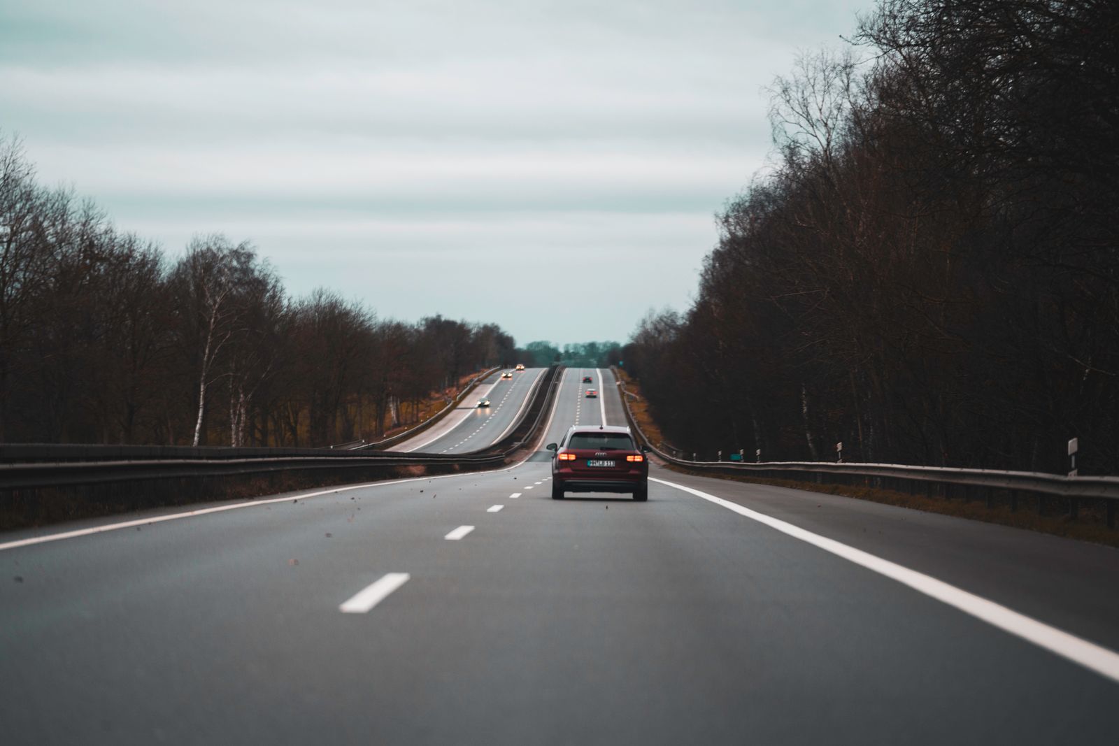 Cars on a highway through the autumn countryside