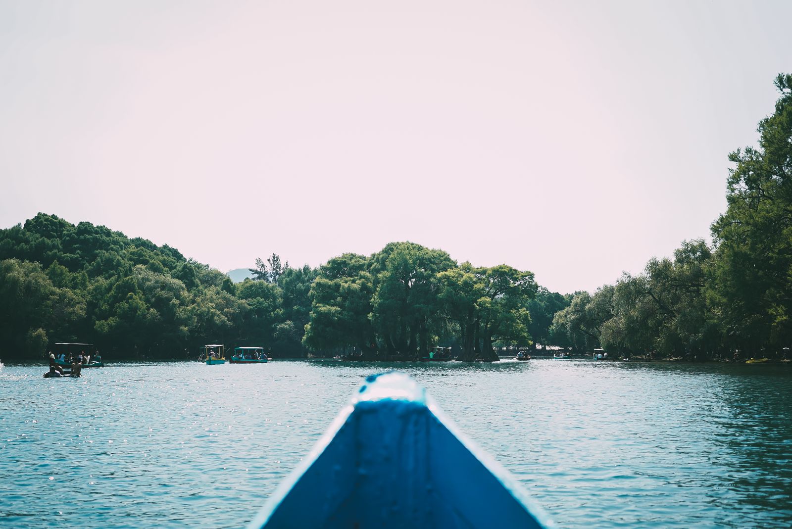 The bow of a boat heading across a lake