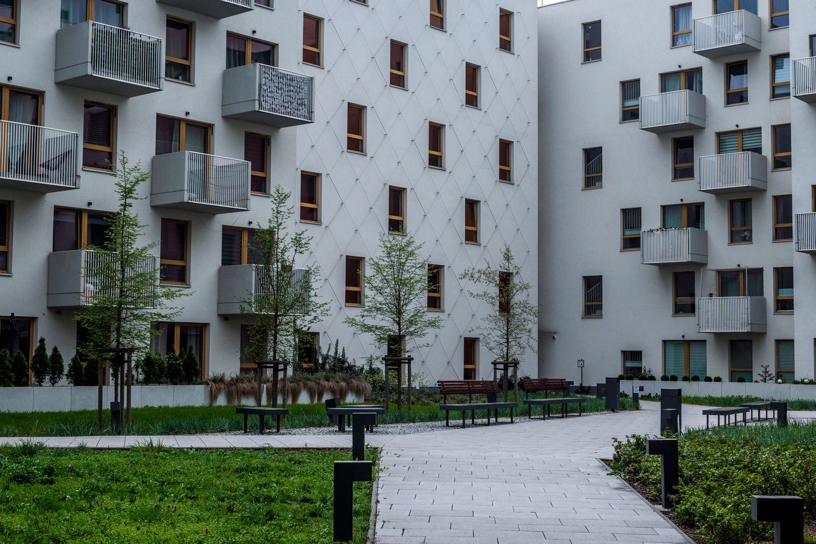 A condo building with a green courtyard