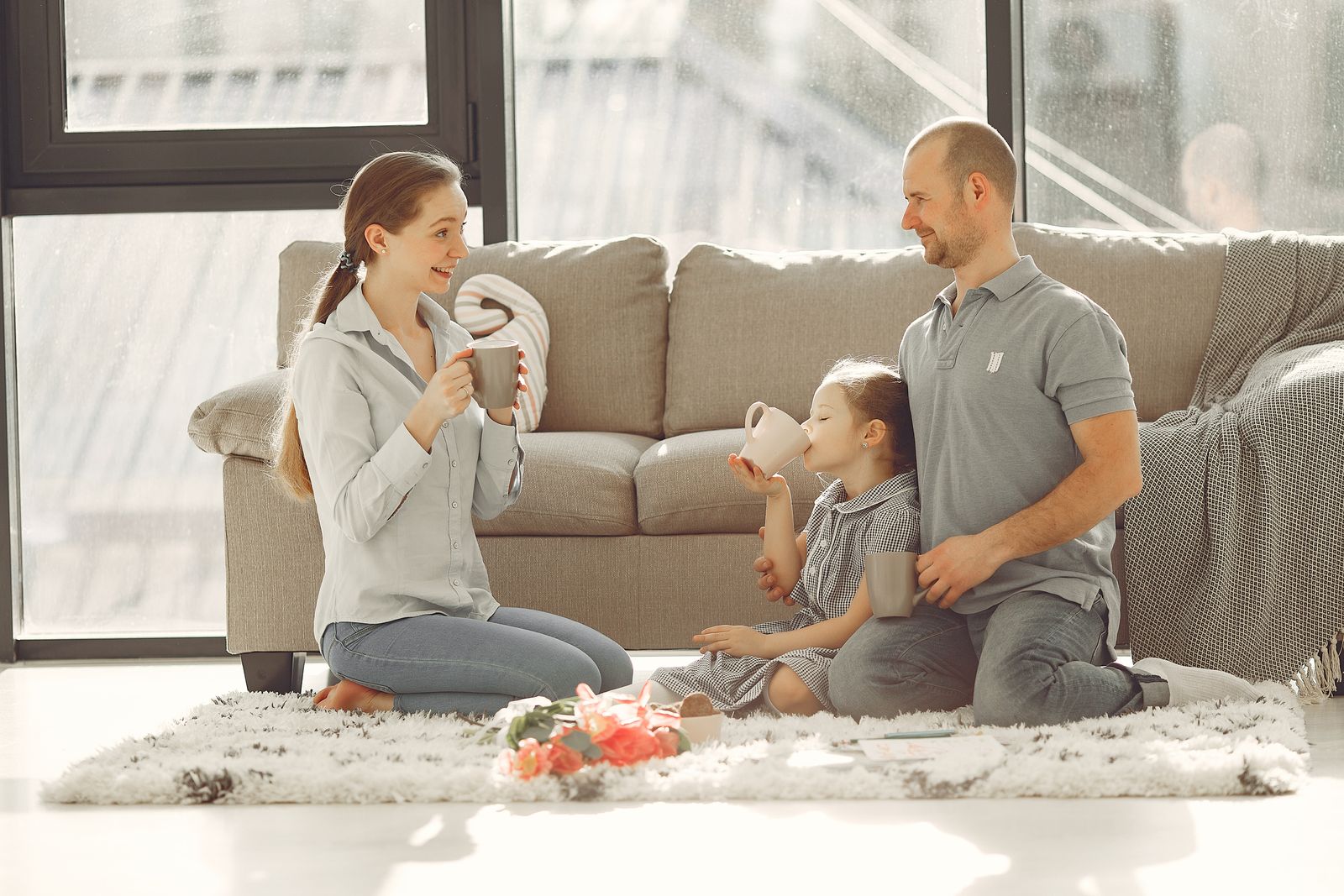 A family playing together on the living room floor