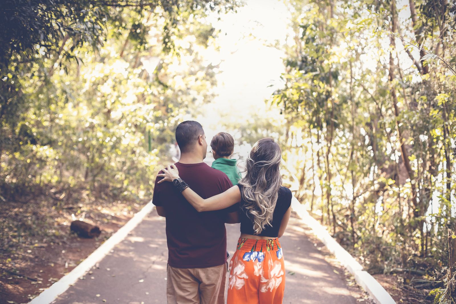 A family walking together down a park path